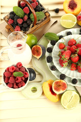 Assortment of juicy fruits and berries on wooden background