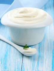 Sour cream in bowl on table close-up