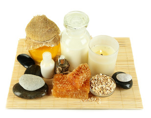 Fototapeta na wymiar Honey and milk spa with oils and honey isolated on white