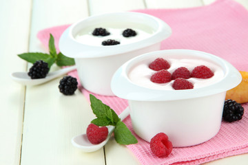 Delicious yogurt with fruit and berries on table close-up