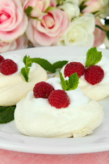 Tasty meringue cakes with berries, close up