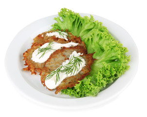 Potato pancakes on plate, isolated on white