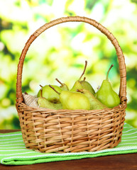 Pears in  wicker basket, on bright background
