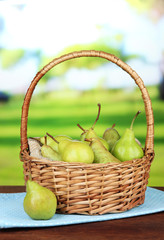 Pears in  wicker basket, on bright background