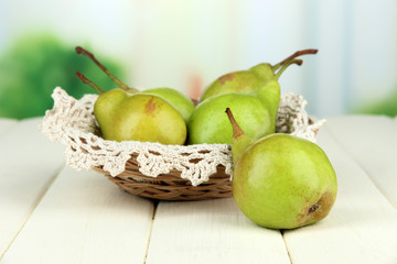 Pears in  wicker basket, on light background