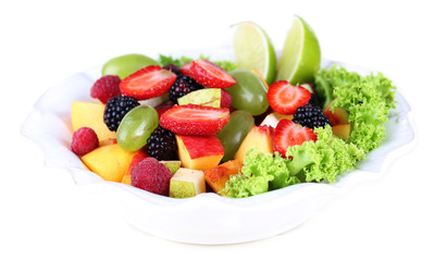 Fruit salad in plate isolated on white