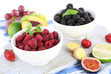 Raspberries and blackberry in small bowls