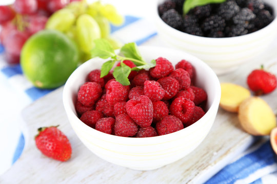 Raspberries and blackberry in small bowls