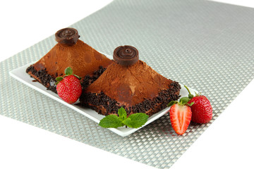 Delicious chocolate cakes on plate close-up