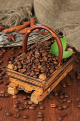 Coffee beans in wooden basket on table close-up