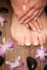 Obraz na płótnie Canvas Relaxing pink manicure and pedicure with a orchid flower