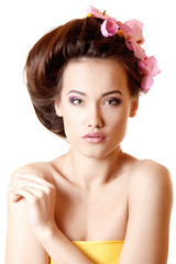 Naklejka premium beautiful teen girl smiling and with flower orchid