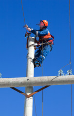electrician working on top of an electricity pylon