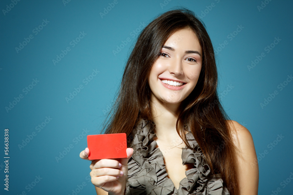 Wall mural beautiful friendly smiling confident girl showing red card in ha