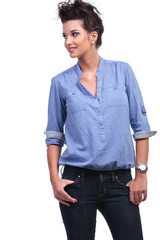 Fototapeta premium casual woman with thumbs in pockets looks away