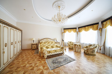 Bedroom with beautiful double bed, wardrobe and armchairs