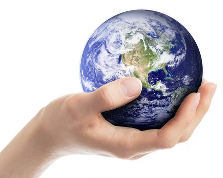 Earth in hand - elements of this image furnished by NASA.