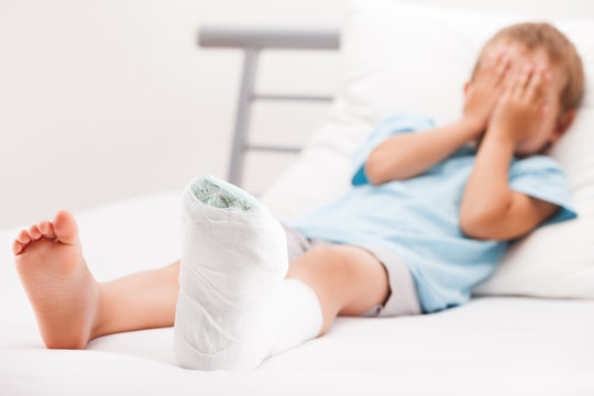 Little Child Boy With Plaster Bandage On Leg Heel Fracture Or Br