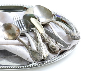 vintage cutlery with old-fashioned napkin on a silver tray