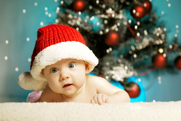 little cute girl with santa hat on blue background
