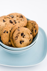 Tasty cookies with chocolate lying on a blue plate