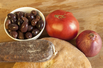 Fresh tomato, onion, olives, bread and dry sausage