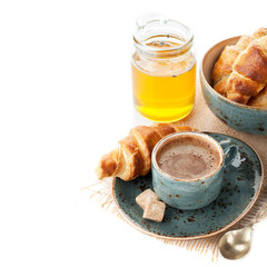 Coffee, croissants and honey for a delicious breakfast