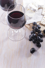 Glasses of red wine and snacks