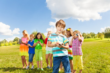 Boy with phone and friends