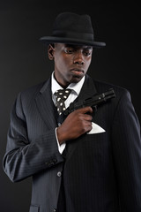 Retro african american mafia man wearing striped suit and tie an