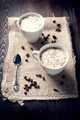 Delicious cup of cappuccino with cinnamon and chocolate