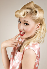 Pin-up style portrait of smiling shy woman
