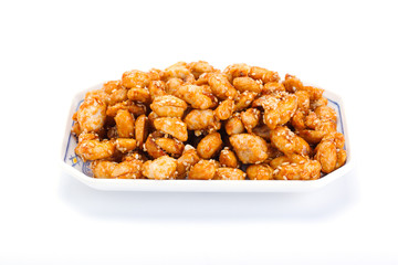 crispy peanut with sesame in plate on white background