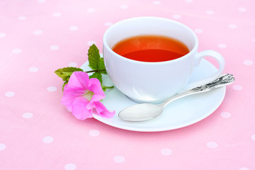 Fresh tea in a white teacup