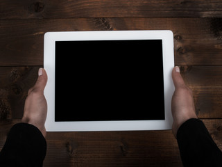 tablet in the hands of the old table