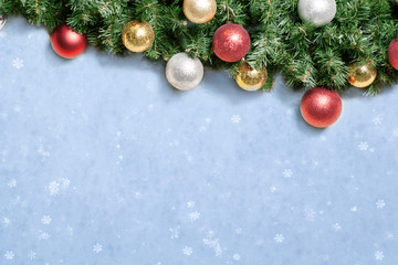Fototapeta na wymiar Christmas decoration with fir and baubles over snow.