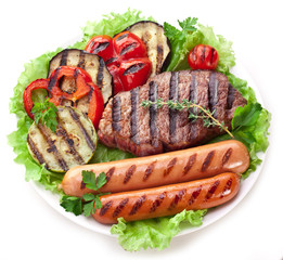 Grilled steak,sausages and vegetables.
