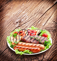 Grilled steak,sausages and vegetables.