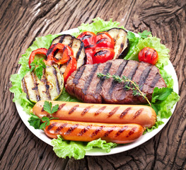 Grilled steak,sausages and vegetables.