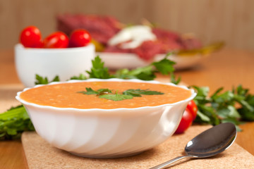 Tasty tomato soup with ingredients.
