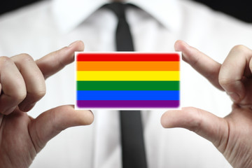 Businessman holding a business card with a Rainbow Flag