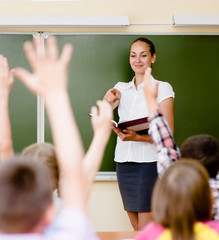 Children raising hands knowing the answer to the question