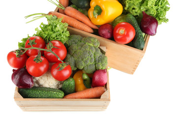 Fresh vegetables in wooden boxes on white background