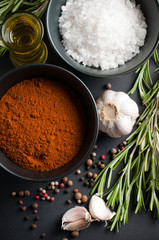 Fototapeta na wymiar spices, rosemary, allspice, garlic, oil and salt