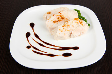 Boiled chicken meat with paprika and sauce, on wooden