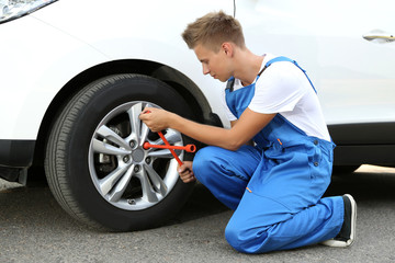 Auto mechanic changing wheel