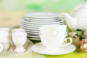 Lots beautiful dishes on wooden table on natural background