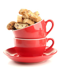 Tasty cookies in cups isolated on white