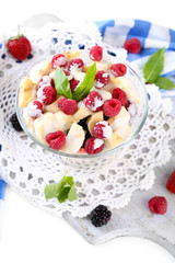 Fruit salad in glass bowl, isolated on white