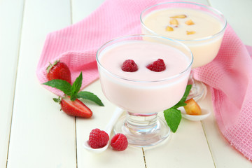 Delicious yogurt with fruit and berries on table close-up